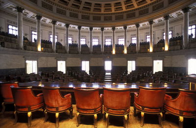 Empty chairs arranged in auditorium