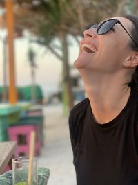 Woman laughing outdoors