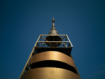 Low angle view of illuminated building against clear blue sky