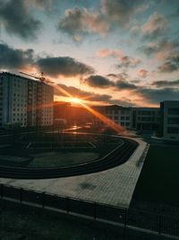 Modern buildings against sky during sunset in city