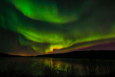 Scenic view of lake against sky at night