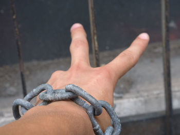 Cropped image of hand in chain gesturing