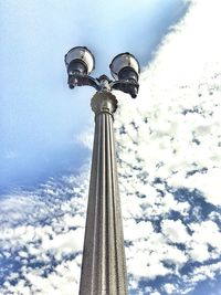 Low angle view of tower against cloudy sky