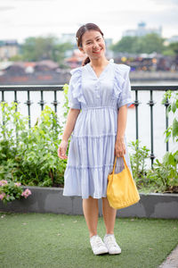 Portrait of a smiling young woman standing outdoors