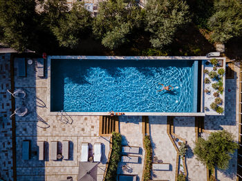 Aerial view of man swimming in swimming pool