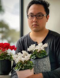 Portrait of man holding flower bouquet