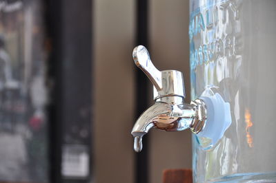 Close-up of faucet in glass door