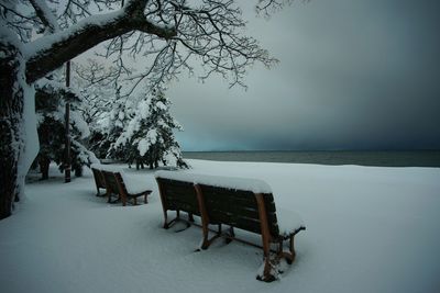 Bench on the lakeshore of biwako lake at snowy morning