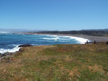 Scenic view of sea against clear blue sky