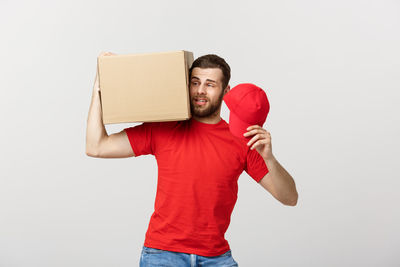 Portrait of young man standing against white background