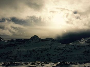Scenic view of snowcapped mountain against cloudy sky