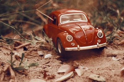 Close-up of abandoned car on field