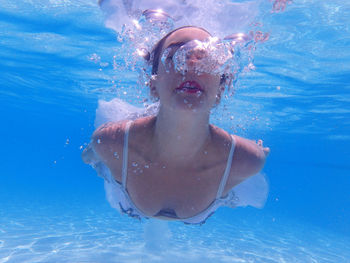 Young woman swimming in pool