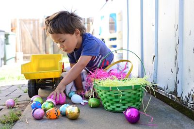 Boy playing with multi colored easter eggs