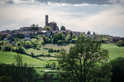 View of trees and buildings against sky