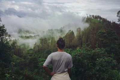 Rear view of woman looking at forest