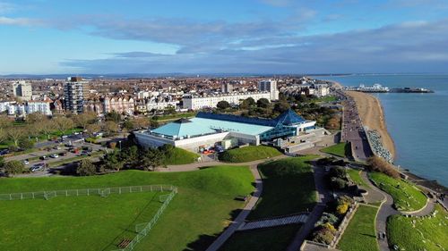 High angle view of buildings by sea against sky