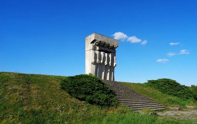 Low angle view of castle on field against sky