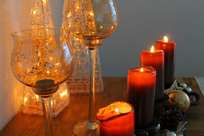 Close-up of lit light candles on table