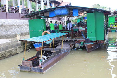 Boat moored on canal in city