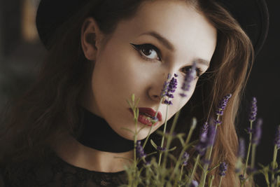 Close-up portrait of young woman with lavender