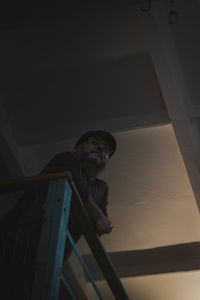 Low angle view of man standing on staircase