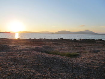 Scenic view of beach against sky during sunset