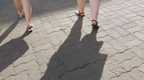 Low section of woman walking on street
