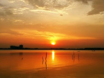 Scenic view of lake against romantic sky at sunset
