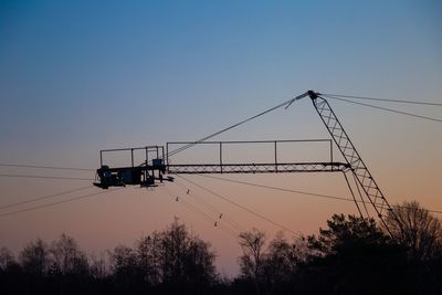 Low angle view of overhead cable car against clear sky