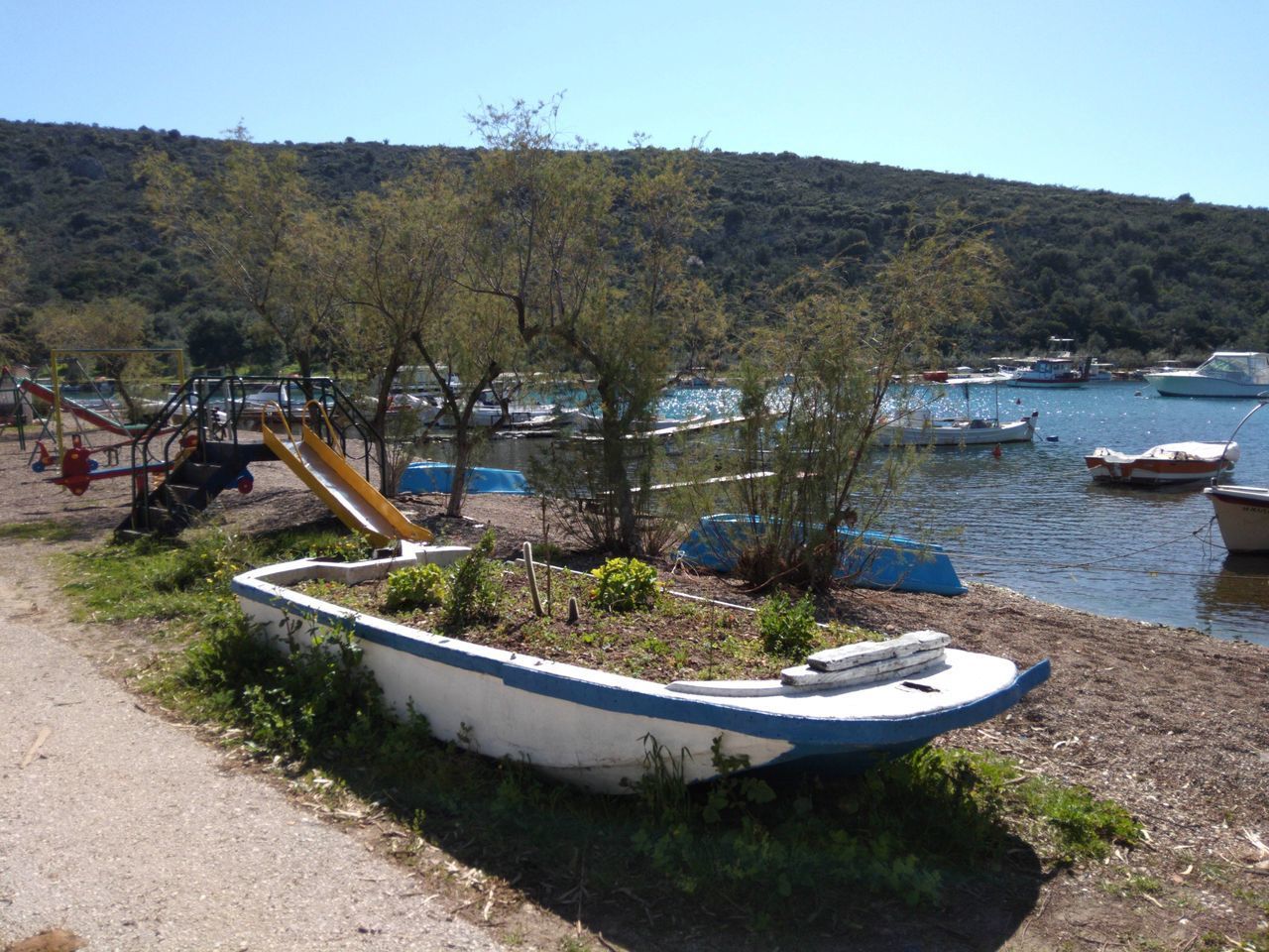 BOATS MOORED ON LAND AGAINST SKY