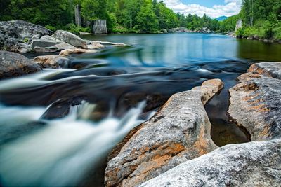 Scenic view of waterfall against sky