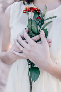 Close-up of hand holding flowers