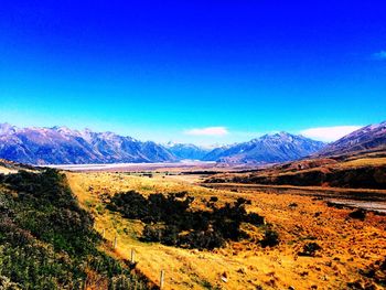 Scenic view of mountains against clear blue sky