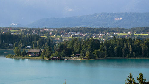 Scenic view of lake by buildings in city