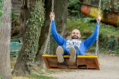 Boy swinging at playground