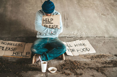 Rear view of man sitting on street