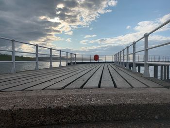 View of bridge over sea against cloudy sky