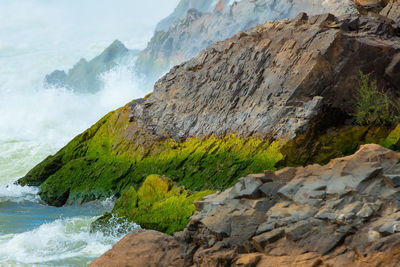 Scenic view of sea against rock formation