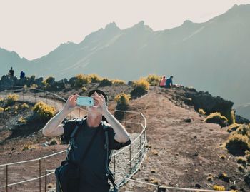 Man photographing at camera