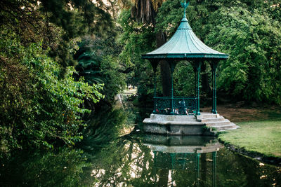 Gazebo by lake in garden