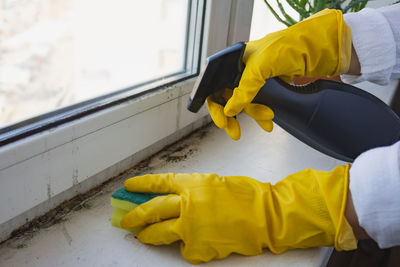 Low section of man cleaning window