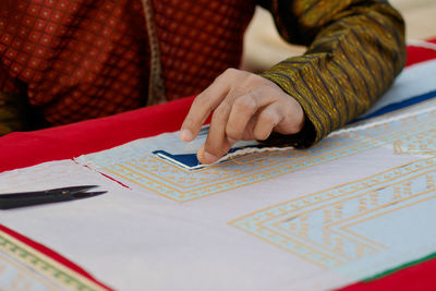 Midsection of woman reading book