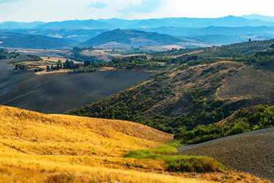 Scenic view of landscape and mountains against sky