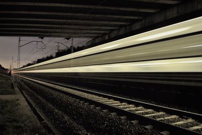 Blurred motion of train on railroad tracks at night