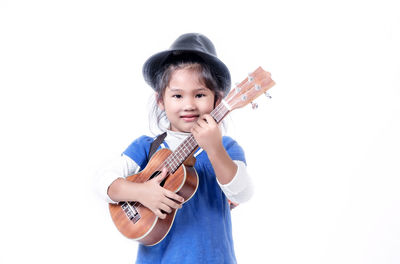 Portrait of happy boy playing with white background