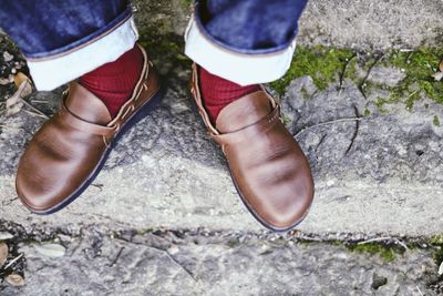 Low section of person standing on footpath