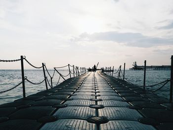 Bridge over sea against sky