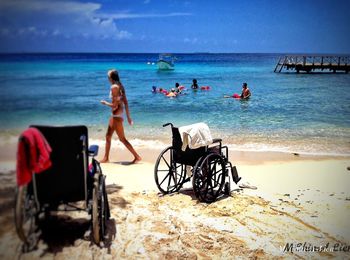 People at beach against sky