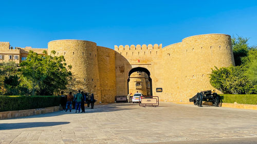 Low angle view of historical building against clear blue sky